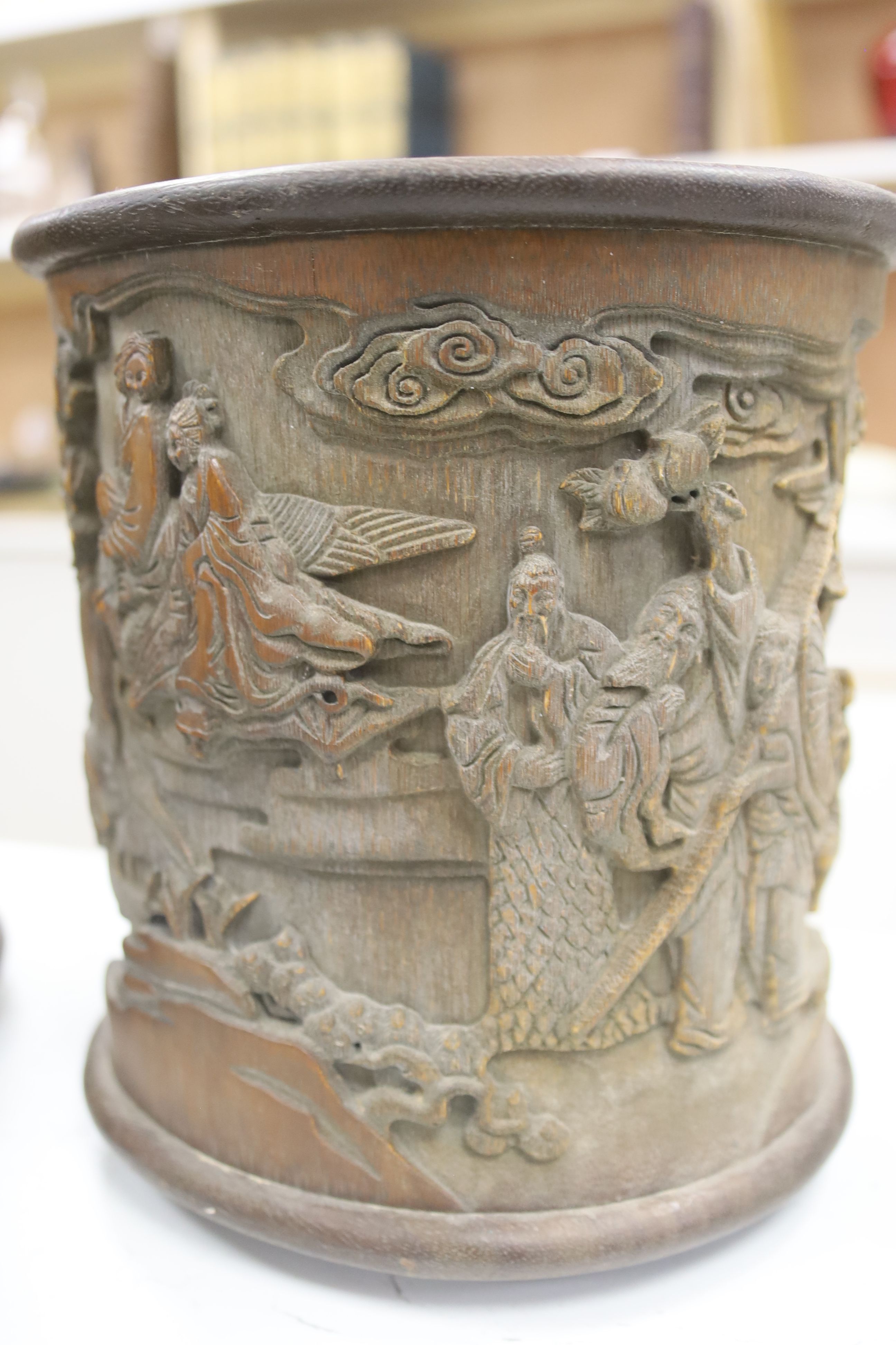 Six 19th/20th century Chinese carved brush pots and a similar carved tea caddy, tallest 20cm